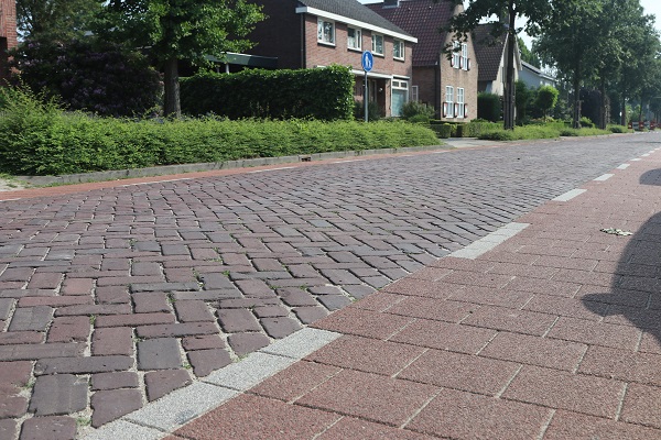 oude situatie: straat ingericht met oude gebakken straatstenen en rode betontegels